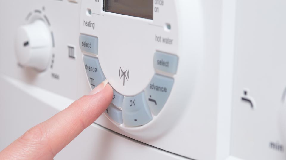 Technician repairing an electric boiler in Fife