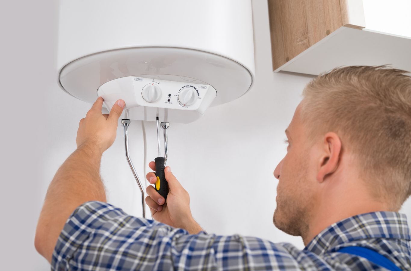 Benefits of Electric Boiler Installation in Glasgow by MPH Boilers An expert from MPH Boilers performing an energy-efficient electric boiler installation in Glasgow, showcasing reliable service.
